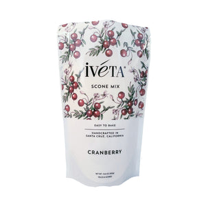 Front: iveta Cranberry Scone Mix. A bag of dry ingredients for making tart and flavorful cranberry scones. Dried cranberries are mixed throughout the flour. "Easy to Bake" and "Handcrafted in Santa Cruz, California" are also on the bag.
